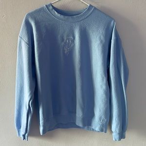 Blue crew neck with a smiley face,  Size medium.